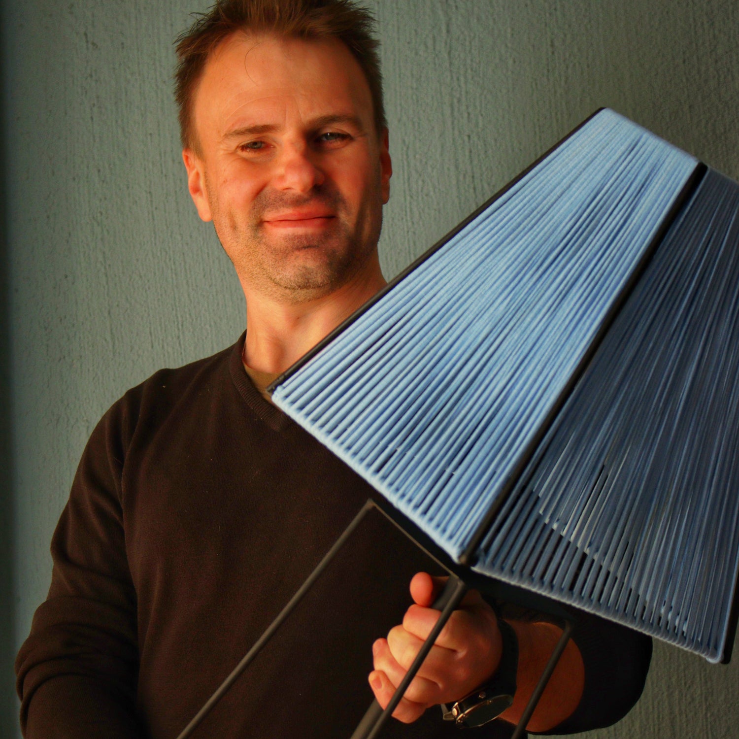 Owner holding Ardhi Emmarias lamp