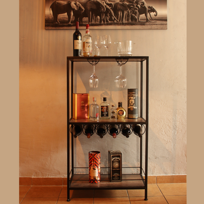 A sleek Ardhi Festio Entertainment Unit with a bar setup, featuring shelves with wine racks and glass holders, positioned against a wall with a decorative painting.