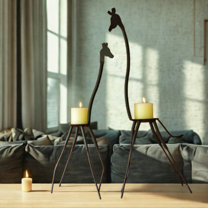 Two giraffe-shaped metal candle holders with lit candles, displayed on a wooden table in a modern living room setting.
