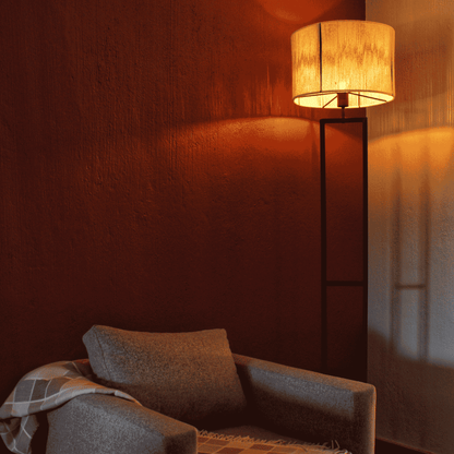 Cozy room with a lamp casting warm light on a chair.