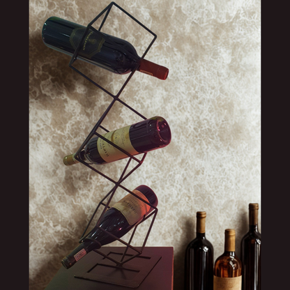Wine bottles on a geometric metal wine rack against a textured wall.