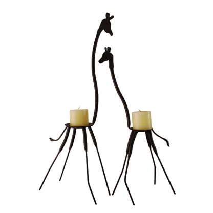 Two black metal giraffe candle holders with candles on a white background