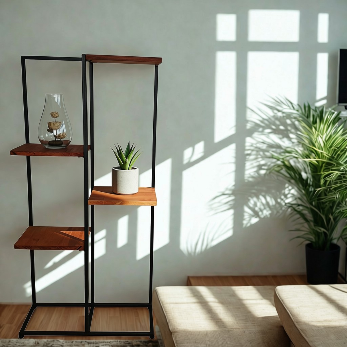 A modern black metal and wood shelving unit styled in a living room setting with a glass vase, a small potted plant, and a large green plant in the background under warm window light.