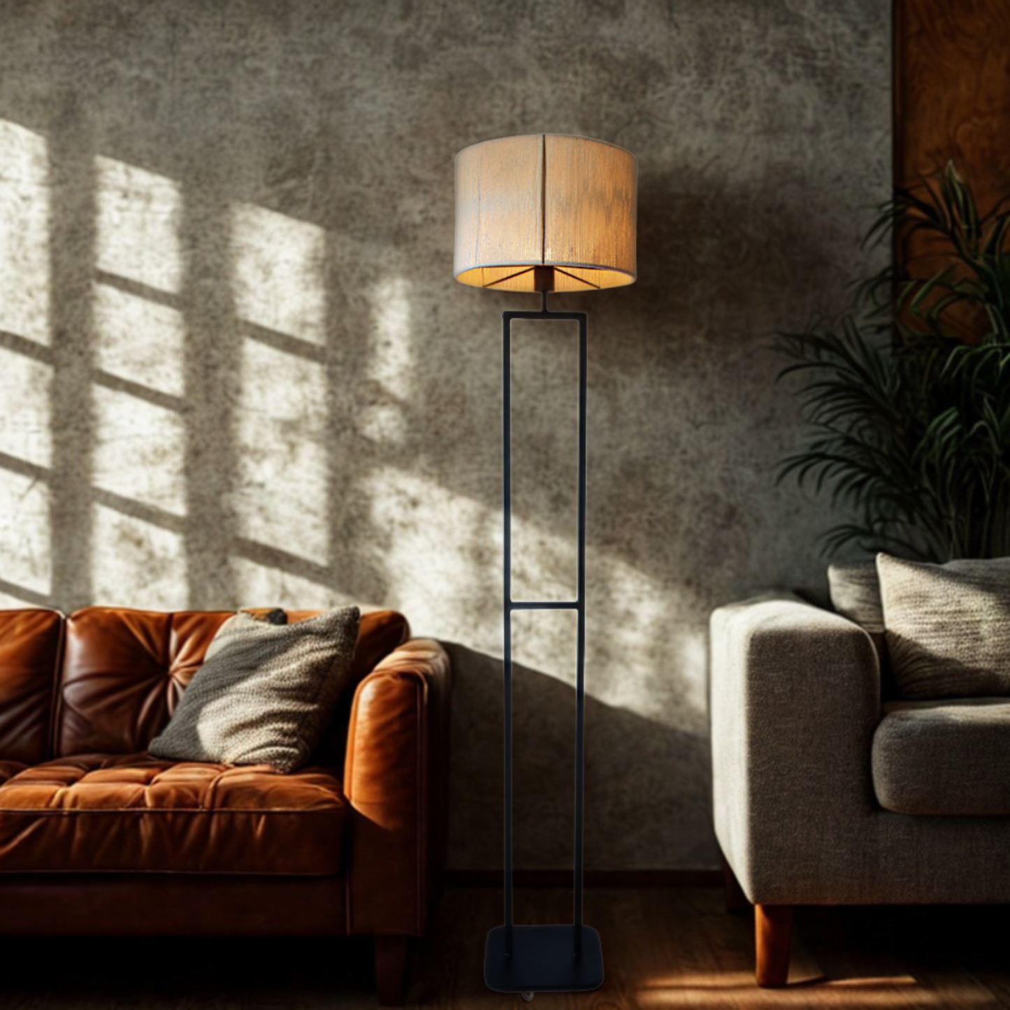 Living room with a brown leather sofa, gray armchair, and standing lamp.